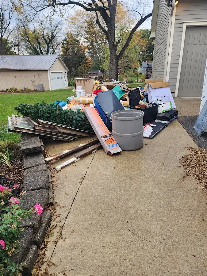 Dumpster being loaded with debris for Estate Cleanout Dumpster Rental in Wake Village